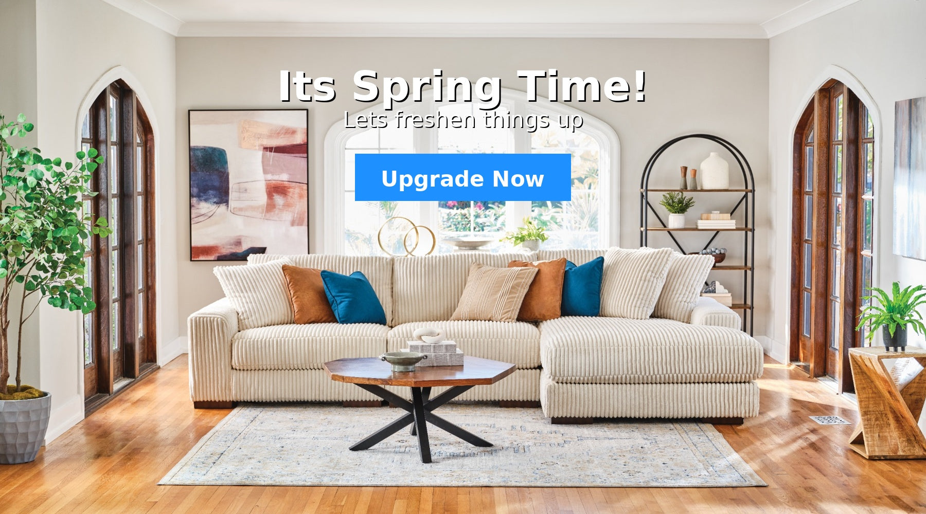 Living room with a beige sofa, coffee table, and decorative items. Prominent text 'It's Spring Time! Upgrade Now' is displayed.
